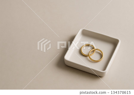 Elegant composition of gold accessories placed on a white tray 134378615