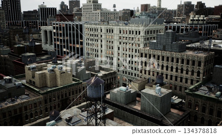 A vibrant city skyline reveals a blend of historic and contemporary architecture. Towers, rooftops, and water towers create an intricate urban landscape filled with activity. 134378818