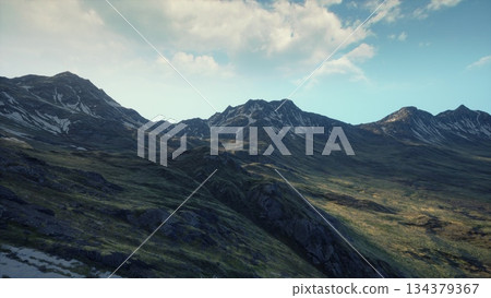 Majestic mountains stretch across the horizon, bathed in soft golden light. The rocky terrain meets lush greenery, creating a harmonious scene that invites exploration and adventure. Majestic mountains stretch across the horizon, bathed in soft golden light. The rocky terrain meets lush greenery, creating a harmonious scene that invites exploration and adventure. 134379367