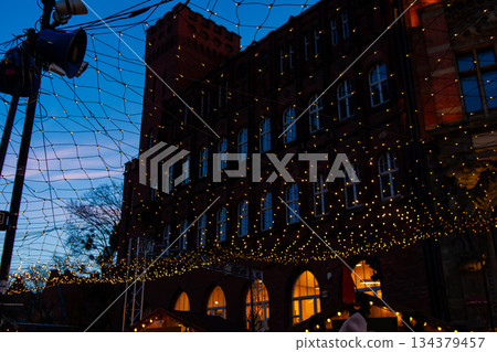 Lights shine on building during evening event in downtown area Lights shine on building during evening event in downtown area 134379457