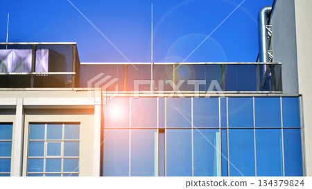 Office building in the evening with lightened workspaces. Modern, glazed skyscraper in financial district. Late hours in the office. Office building in the evening with lightened workspaces. Modern, glazed skyscraper in financial district. Late hours in the office. 134379824