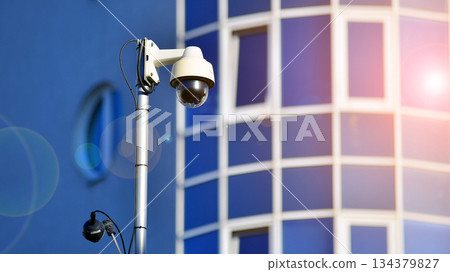 Office building in the evening with lightened workspaces. Modern, glazed skyscraper in financial district. Late hours in the office. 134379827