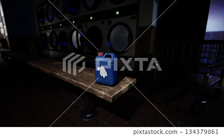 In a quiet laundromat, a bright blue container sits on a wooden bench, illuminated by soft lights from the washing machines. The atmosphere feels calm and serene during the late evening hours. In a quiet laundromat, a bright blue container sits on a wooden bench, illuminated by soft lights from the washing machines. The atmosphere feels calm and serene during the late evening hours. 134379861