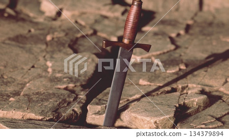 At the heart of a large cracked stone, a gleaming sword stands upright. The sunlight glints off its blade, while the rugged terrain tells tales of ancient battles and heroic legends. At the heart of a large cracked stone, a gleaming sword stands upright. The sunlight glints off its blade, while the rugged terrain tells tales of ancient battles and heroic legends. 134379894