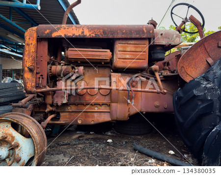 Old rusty vehicles in a vintage industrial setting Old rusty vehicles in a vintage industrial setting 134380035