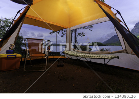 Camping tent, view from inside the tent to see the view outside the mountain, forest, lake, camping tent on a high mountain 134380126