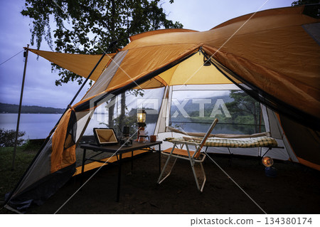 Camping tent, view from inside the tent to see the view outside the mountain, forest, lake, camping tent on a high mountain 134380174
