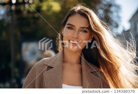 Portrait of beautiful woman that is outdoors in the town 134380370