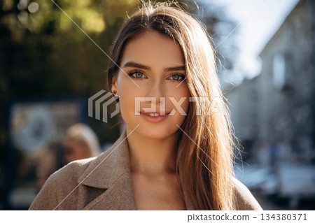 Portrait of beautiful woman that is outdoors in the town 134380371