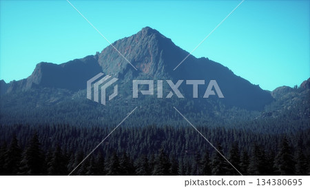 A majestic mountain peak towers over a dense forest of evergreen trees under a clear blue sky. The sunlight illuminates the rocky summit, creating a breathtaking scene. A majestic mountain peak towers over a dense forest of evergreen trees under a clear blue sky. The sunlight illuminates the rocky summit, creating a breathtaking scene. 134380695