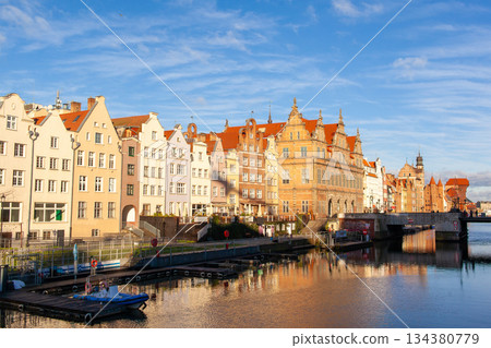 Historic buildings line the waterfront in Gdansk with clear skies above Historic buildings line the waterfront in Gdansk with clear skies above 134380779