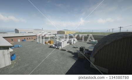 An expansive industrial area features several warehouses filling the landscape, stacked materials, and equipment arranged around a wide gravel lot under a bright, clear sky. An expansive industrial area features several warehouses filling the landscape, stacked materials, and equipment arranged around a wide gravel lot under a bright, clear sky. 134380780