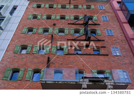 Historic brick building with green shutters in an urban area Historic brick building with green shutters in an urban area 134380781
