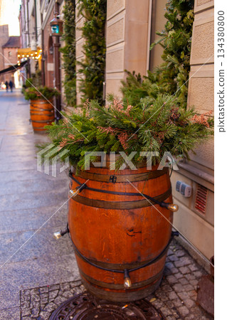 Decorative wooden barrels with greenery on a city street in winter season Decorative wooden barrels with greenery on a city street in winter season 134380800