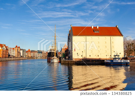 History and architecture along the water in Gdansk, Poland with boats 134380825