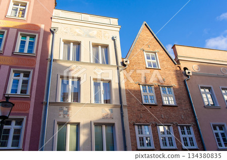 Old buildings stand side by side in a city under clear blue sky Old buildings stand side by side in a city under clear blue sky 134380835