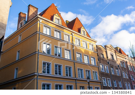 Buildings in a city under a blue sky with clouds on a sunny day 134380841