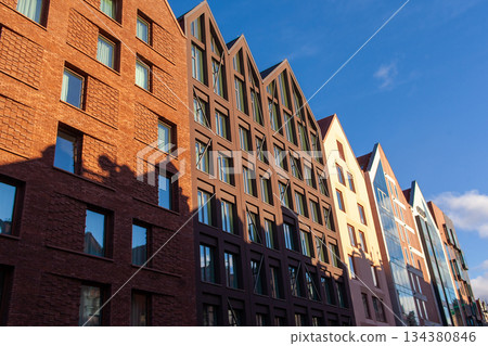 Modern buildings along a street in a city on a sunny day Modern buildings along a street in a city on a sunny day 134380846