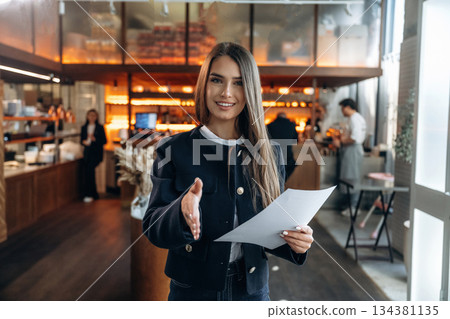 Restaurant owner or manager is standing indoors Restaurant owner or manager is standing indoors 134381135