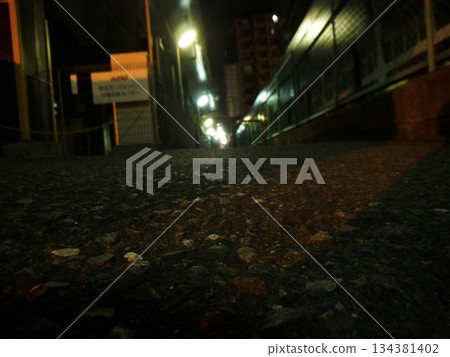 夜幕降臨，從低處俯瞰鐵路橋下的巷道 134381402