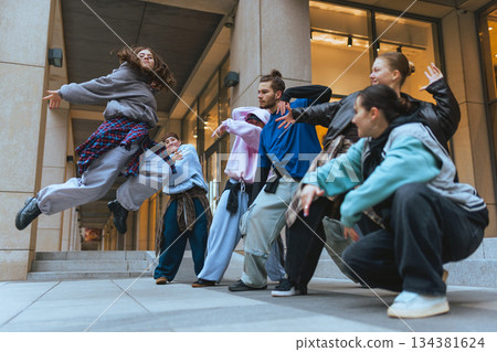 Hip hop dancers training together in public space during practice session. 134381624