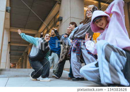 Street dancers performing coordinated routine in modern city location. Street dancers performing coordinated routine in modern city location. 134381626