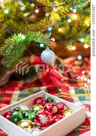 Decorations for Christmas Tree , silver and red Balls Garlands Lights on red green Background Holidays Home Decor toy Decorations for Christmas Tree , silver and red Balls Garlands Lights on red green Background Holidays Home Decor toy 134381987