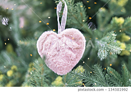 Christmas tree with pink fluffy soft heart in bokeh light decoration holiday decorations New year concept merry Christmas background greeting card Christmas tree with pink fluffy soft heart in bokeh light decoration holiday decorations New year concept merry Christmas background greeting card 134381992
