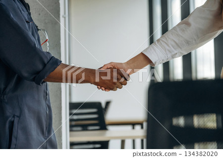 Handshake, made a deal. Two business people are working together in the office Handshake, made a deal. Two business people are working together in the office 134382020
