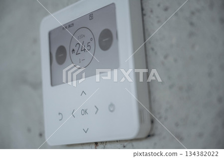 Thermostat on the wall, showing current temperature in the room Thermostat on the wall, showing current temperature in the room 134382022