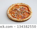Appetizing pizza with four types of meat on a wooden board on a white background 134382550