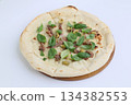 Tasty pizza with anchovies and basil on cream sauce on wooden board on white background 134382553