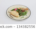 Veal tartare with dry wheat bread on a white plate on a white background 134382556