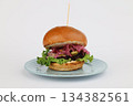 Burger with pork and beef cutlet on a plate on a white background 134382561