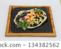 Classic shrimp with avocado and greens on a wooden board on a white background 134382562