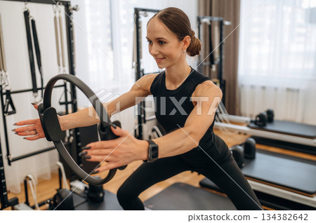 Young woman is in the gym with training equipment 134382642