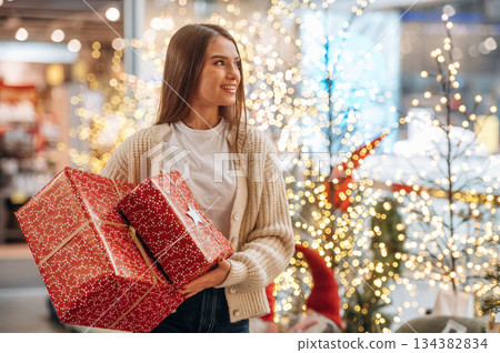 Gorgeous woman is with new year gifts near the Christmas tree Gorgeous woman is with new year gifts near the Christmas tree 134382834