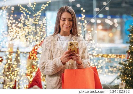 Joy and happiness. New year shopping and presents. Woman is near the Christmas tree 134382852