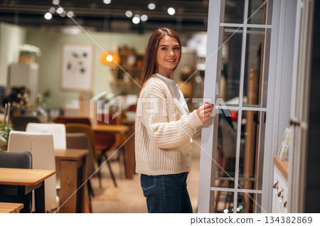 Woman is in the shop with decoration, indoors 134382869