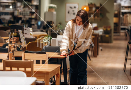 Woman is in the shop with decoration, indoors 134382870