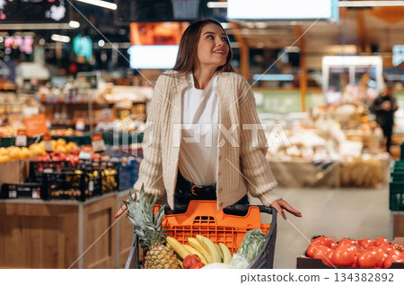 Beautiful woman is in the supermarket Beautiful woman is in the supermarket 134382892