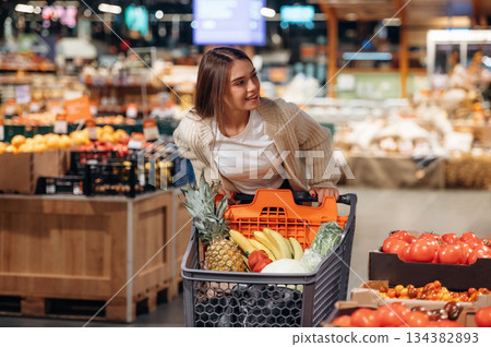 Beautiful woman is in the supermarket 134382893