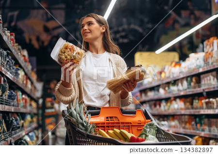 Beautiful woman is in the supermarket 134382897