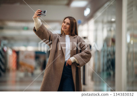 Making a selfie. Beautiful woman is in the mall, conception of shopping Making a selfie. Beautiful woman is in the mall, conception of shopping 134383032