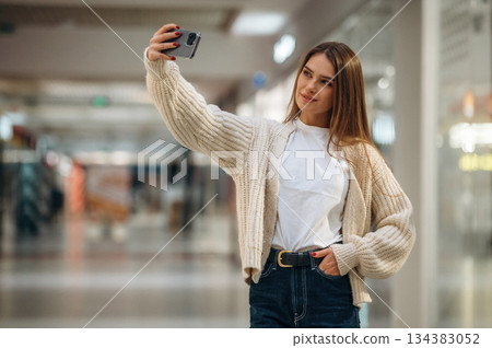 Making a selfie. Beautiful woman is in the mall, conception of shopping Making a selfie. Beautiful woman is in the mall, conception of shopping 134383052
