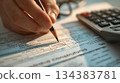 Hand Writing on Document with Calculator and Pencil 134383781