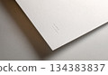 Textured White Paper Background with Soft Shadow and Faint Print 134383837