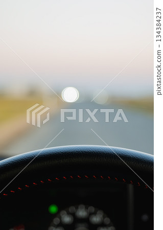 A view from the driver's seat in the early morning, with bokeh balls of light floating A view from the driver's seat in the early morning, with bokeh balls of light floating 134384237