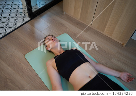 Calm post-workout rest with warm restorative energy 134384253
