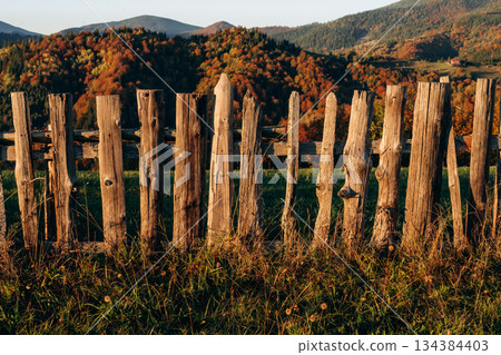 Wooden fence is in the Carpathian mountains, autumn season Wooden fence is in the Carpathian mountains, autumn season 134384403